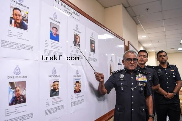 Bukit Aman Commercial Crime Investigation Department (CCID) director Datuk Seri Ramli Mohamed Yoosuf displays photos of seven individuals wanted over the Gigamax investment scam, at Menara KPJ in Kuala Lumpur, on Dec 17, 2024. — Bernama pic