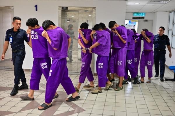 The 12 suspects are seen in the custody of police in Kuala Terengganu December 18, 2024. — Bernama pic