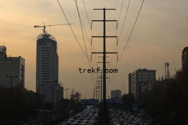 Traffic flows on a main road past electricity transmission towers in Tehran on December 16, 2024. — AFP pic