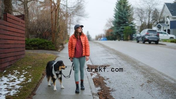 Female walks outside with dog